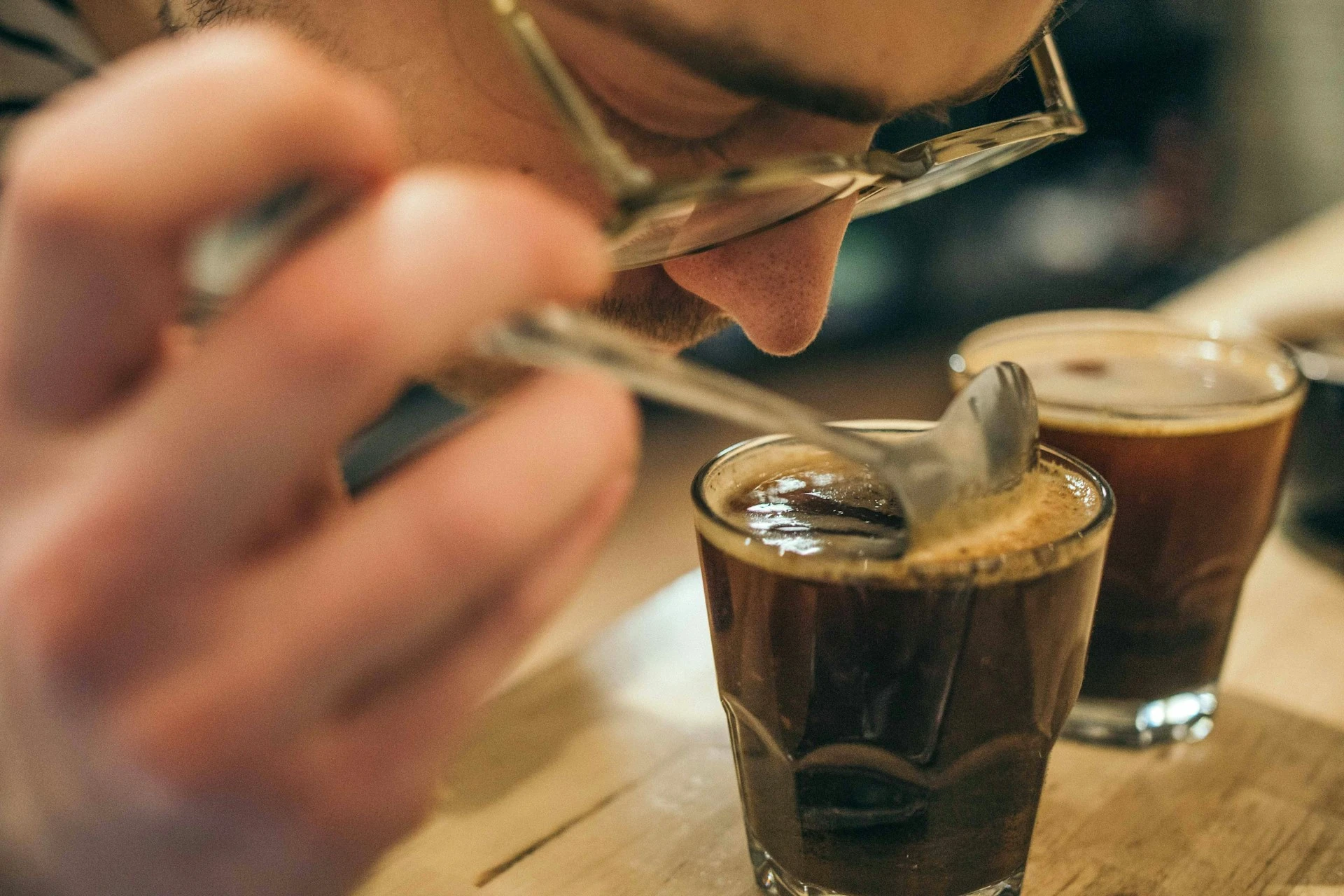 a man smell coffee aroma when coffee cupping process